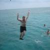 Goofing off between dives: With a running start, we jumped off the boat using the boom swing, tarzan-style